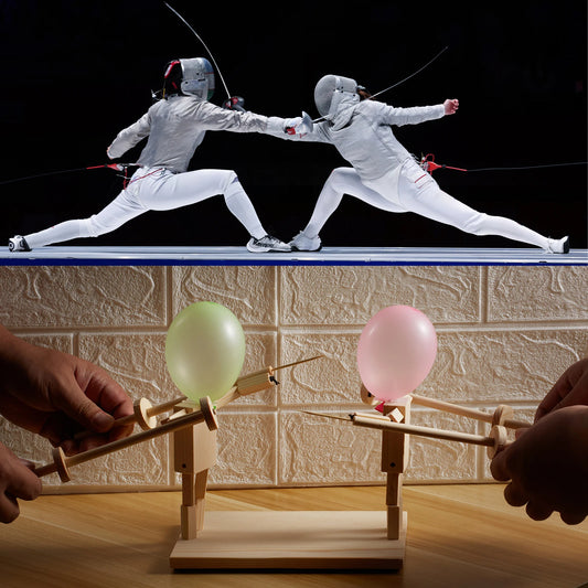 Two people in fencing gear engaging in a duel above a wooden device with balloons.